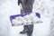 A woman cleans the snow in her yard in a country house.