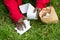 A woman cleans up dog poop on the lawn in the yard of the house. Close-up. Roll of toilet paper and excrement on the grass.