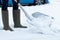 Woman Clearing Winter Snow From Path With Shovel