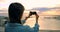 Woman clicking photos with mobile phone at beach 4k