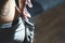 Woman climber is chalking hands with white chalk powder before climb in indoor climbing gym. woman getting ready to