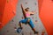 Woman Climber Practicing Rock-climbing in the Bouldering Gym. Extreme Sport and Indoor Climbing Concept