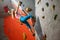 Woman Climber Practicing Rock-climbing in the Bouldering Gym. Extreme Sport and Indoor Climbing Concept