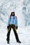 Woman climber stands in the cleft of the glacier