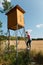 Woman climbing on high seat for hunters