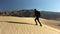 woman climbing a sand dune