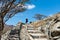 Woman climbing stairs to desert fortress