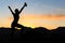 Woman climbing success silhouette in mountains sunset