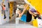 Woman climbing tall, indoor, man-made rock climbing wall