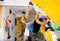 Woman climbing tall, indoor, man-made rock climbing wall