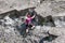 Woman climbing a vertical rock along river Meuse in Belgium