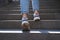 Woman climbs stairs to street closeup. Daily walks and healthy lifestyle