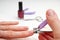 Woman Clipping Nail s with Forceps. Female cuts his nails on a white background with tweezers for nails. manicure procedures