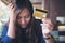 Woman close her eyes while holding credit card with feeling stressed and broke