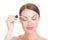 Woman with closed eyes, applying serum essence essential oils to her eyebrows
