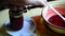 Woman closes a lid of handmade raspberry jam in jar