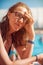 Woman closeup portrait relaxing by pool