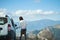 Woman closing door of car, reaching destination on road trip to mountains valley in Turkey