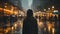 woman in a coat walking slowly in the rain under the glow of street lights