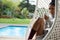 Woman with coffee cup resting in swing chair