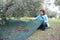 Woman collecting olives on olive harvesting net