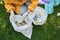 Woman collecting rubbish outdoors in the nature and sorting it into the different bags