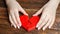 A woman collects a broken heart in his hands. Concept of love and relationships. Family psychotherapist services. Reconciliation.