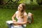 Woman college student with book studing in park