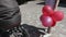 Woman with colorful balloons near the baby carriage close up