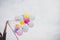 Woman with colorful balloons outside blue sky.