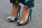 Woman with colorful glitter high heel shoes with gems and jewels decoration before Giorgio Armani fashion