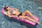 woman on colorful pool float