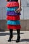 Woman with colorful skirt with fringes before Stella Jean fashion show, Milan Fashion Week street style on