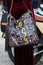 Woman with colorful snake leather and fringes before Gucci fashion show, Milan Fashion Week street style on