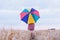 Woman with colorful umbrella in the field, optimistic positive concept