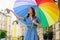 Woman with colorfull umbrella at the city center