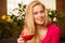 Woman comfortable sitting on sofa surrounded with lemon tree and