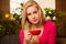 Woman comfortable sitting on sofa surrounded with lemon tree and