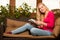 Woman comfortable sitting on sofa and using tablet computer.