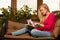 Woman comfortable sitting on sofa and using tablet computer.