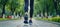 Woman in comfortable sneakers taking a leisurely stroll in the urban park on a sunny summer day