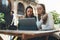 Woman communicate on design project, girls online shopping in cafe outdoor. Students studies on internet