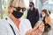 Woman commuter with face mask uses smartphone warning app