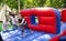 Woman competing to collect hoops on inflatable playground