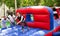 Woman competing to collect hoops on inflatable playground