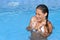 Woman complaints in a cold water of a swimming pool