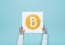 Woman completing a puzzle with a bitcoin icon