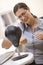 Woman in computer room using small punching bag