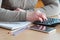 A woman conducts accounting calculations in the office