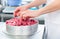 Woman confectioner making raspberry cake